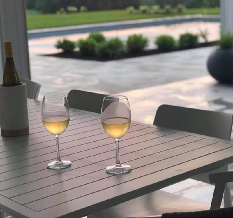 a table with wine glasses and a bottle on it