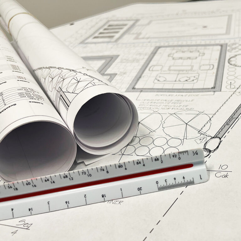 a ruler and rolls of blueprints